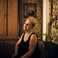 Jean Bruno in the living room of the house on Snyder Avenue. A portrait of her father hangs on the wall. Photograph by Chris Crisman