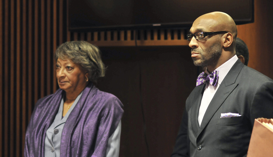 Former NFL football star, Irving Fryar, right, and his mother Allene McGhee appear before Judge James W. Palmer in Burlington County Superior Court in Mount Holly, N.J., Tuesday, Jan. 21, 2014, as they pleaded not guilty to charges that they conspired to steal more than $690,000 through a mortgage scam. State prosecutors allege Fryar's 80-year-old mother, Allene McGhee, of Willingboro, N.J., submitted false information to obtain five loans on her home within a six-day period. (AP Photo | Dennis McDonald)