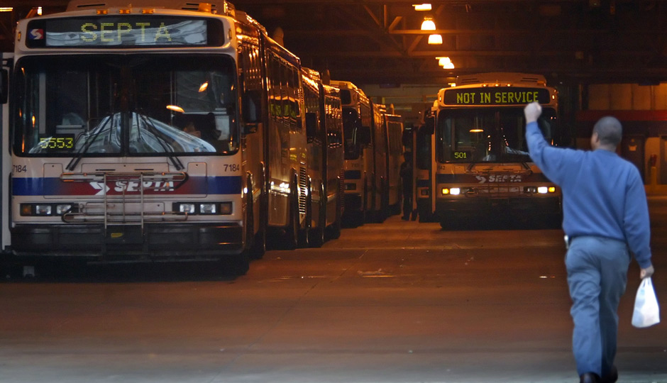 An employee of Southeastern Pennsylvania Transportation Authority raises his fist in the air, Friday, Oct. 28, 2005, while entering a SEPTA bus depot in north Philadelphia. | AP Photo, Joseph Kaczmarek
