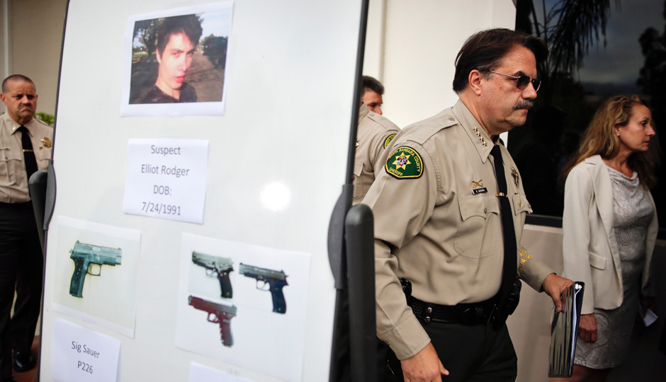 Santa Barbara County Sheriff Bill Brown, right, walks past a board showing the photos of suspected gunman Elliot Rodger and the weapons he used in Friday night's mass shooting that took place in Isla Vista, Calif., after a news conference on Saturday, May 24, 2014, in Santa Barbara, Calif. Sheriff's officials say Rodger, 22, went on a rampage near the University of California, Santa Barbara, stabbing three people to death at his apartment before shooting and killing three more in a crime spree through a nearby neighborhood. (AP Photo | Jae C. Hong) 