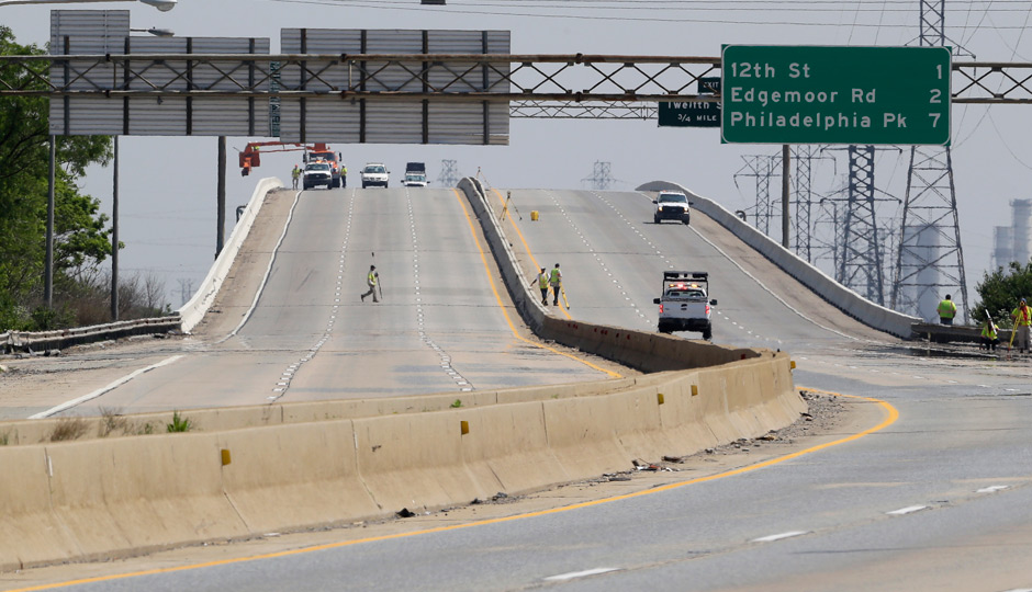 Crews work on the Interstate 495 bridge over the Christina River near Wilmington, Del., Tuesday, June 3, 2014, after it was closed due to the discovery of four tilting support columns. The closure created heavier-than-normal traffic conditions for motorists on Interstate 95, a major East Coast artery. The bridge normally carries about 90,000 vehicles a day. (AP Photo/Patrick Semansky) 