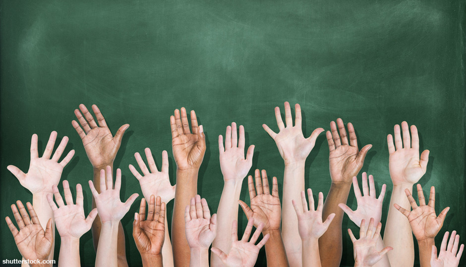 shutterstock_hands-raised-school-chalkboard-940x540