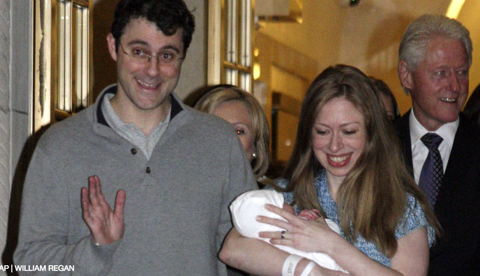 Chelsea Clinton, second from right, leaves Manhattan's Lenox Hill hospital with her newborn baby, Charlotte, husband Marc Mezvinsky, left, mother Hillary Clinton, partly visible, second from left, and father Bill Clinton, in New York, Monday, Sept. 29, 2014. Charlotte was born Friday, Sept. 26, 2014.