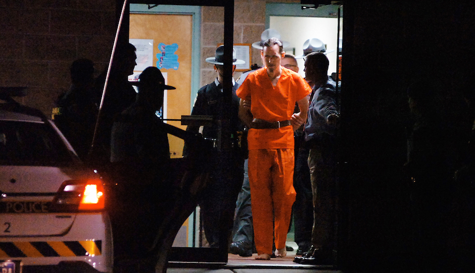Pennsylvania State Police Troopers take away suspected killer Eric Frein from the Blooming Grove State Police barracks early Friday, Oct. 31, 2014, in Blooming Grove Township, Pennsylvania. (AP Photo /The Scranton Times-Tribune, Butch Comegys)