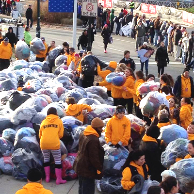 Volunteers collecting discarded clothing after the Philadelphia Marathon.