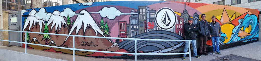 Volcom Muralist Eric Gordon stands between Bill Van Gilder (left) and Jeff Mattes (right) in front of Gordon's mural. 