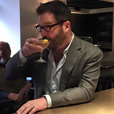 Daniels enjoying the drink named after his character at a.bar.