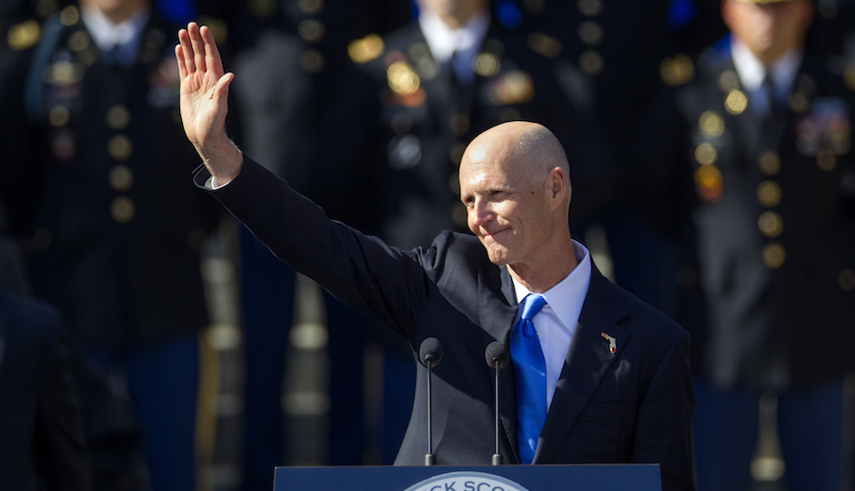 Florida Gov. Rick Scott waves after the swearing in for his second term as governor of Florida at the Florida state capitol in Tallahassee, Fla., Tuesday, Jan. 6, 2015. The inauguration took place in front of the Old Capitol. (AP Photo/Mark Wallheiser)