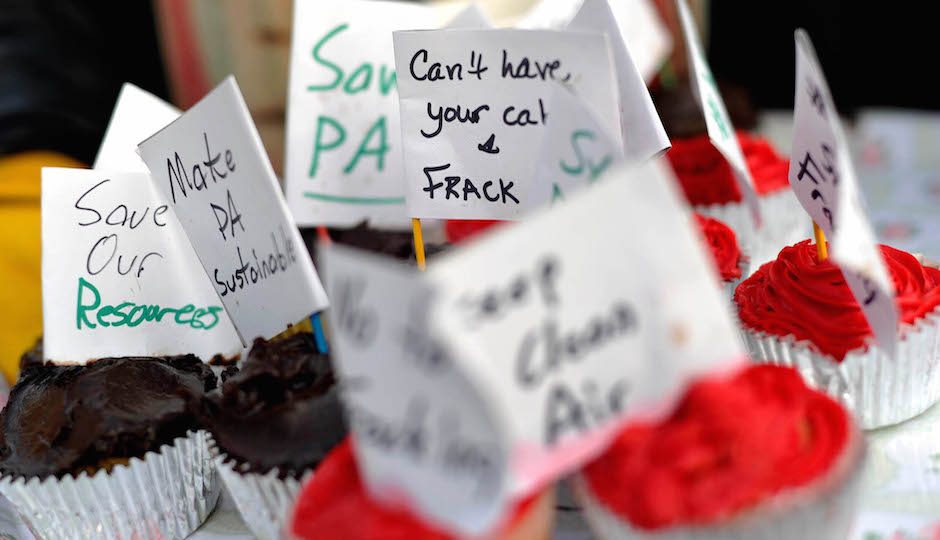 Cupcakes with anti-fracking messages are offered to those in line during an open house at the governor's residence in Harrisburg Tuesday, January 20, 2015. Governor Tom Wolf and his wife hosted the event after the inauguration ceremony that morning.  (AP Photo/Daily Record/Sunday News, Kate Penn)
