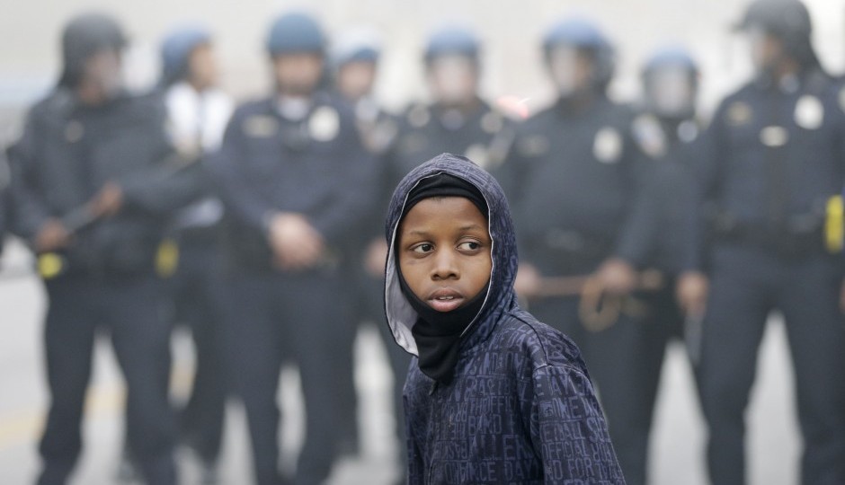 Police move a protester back following the funeral of Freddie Gray in Baltimore. | Photo by Matt Rourke, Associated Press