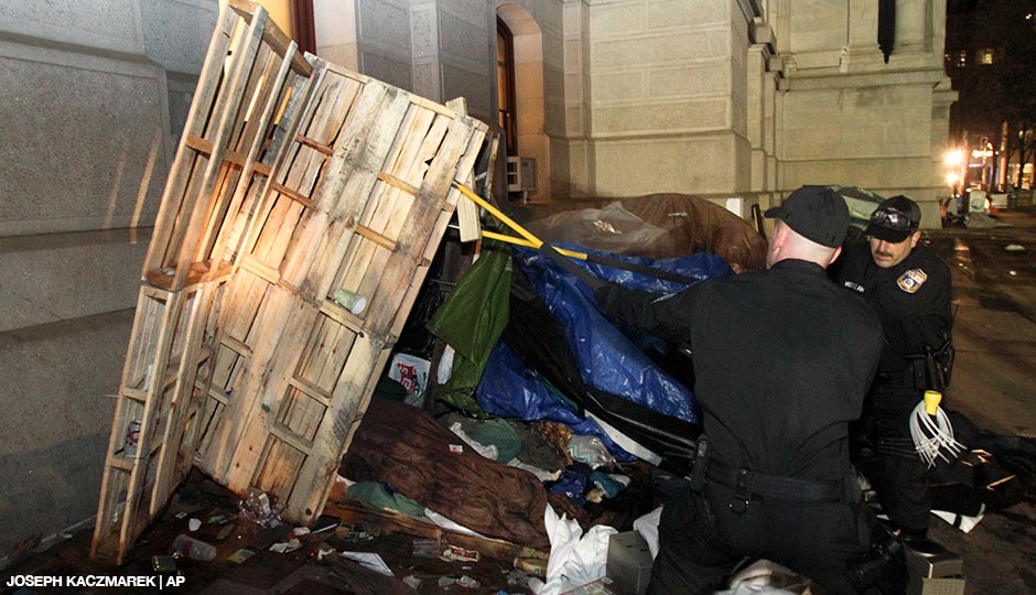 Police officers pull down structures at the Occupy Philly encampment inside Dilworth Plaza, in Philadelphia, Wednesday Nov. 30, 2011. 