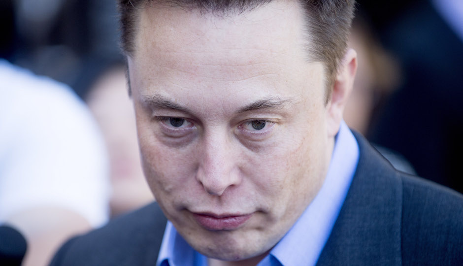 Tesla CEO Elon Musk speaks with members of the media at Tesla's headquarters in Palo Alto, Calif., Thursday, April 30, 2015. (AP Photo/Noah Berger)