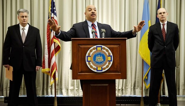Philadelphia District Attorney Seth Williams, center, accompanied by investigators Marc Costanzo, left, and Frank Fina, speaks during a news conference Monday, Jan. 27, 2014, in Philadelphia.
