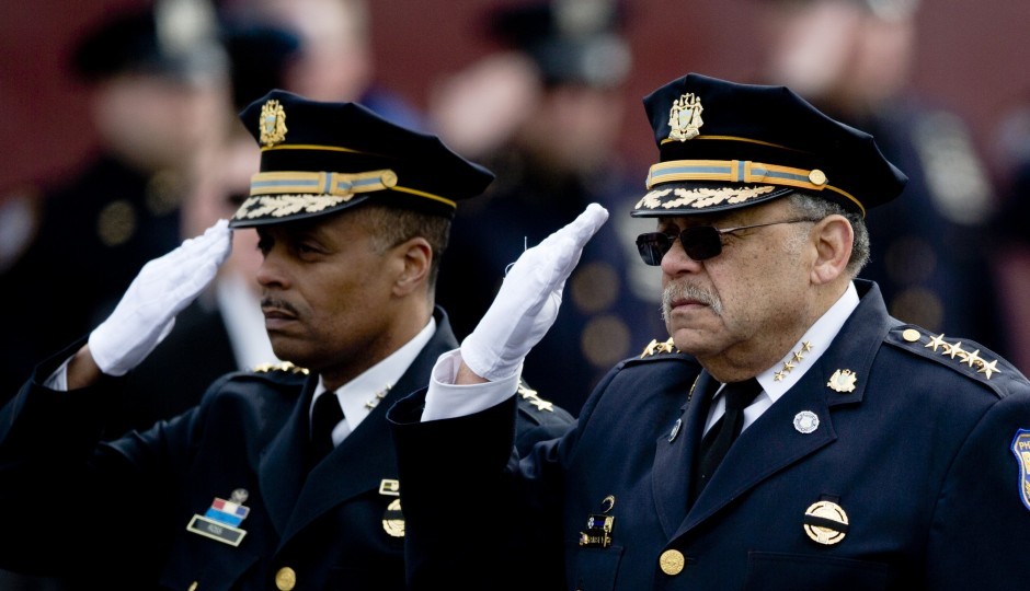 Police Commissioner Charles Ramsey, right, and his likely replacement, First Deputy Commissioner Richard Ross Jr., salute the family of slain Philadelphia Police Officer Robert Wilson III on Friday, March 13, 2015, in Philadelphia. (AP Photo/Matt Rourke)