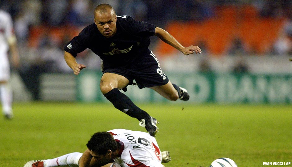 Earnie Stewart, then a midfielder for DC United, jumps over a slide tackle by Chicago Fire forward Ante Razov in the first half of a Saturday, November 1, 2003, game in Washington.