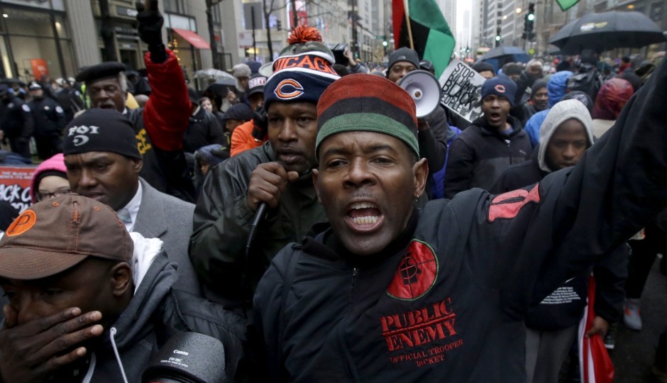 Protesters make their way up North Michigan Avenue on Friday, Nov. 27, 2015, in Chicago. Community activists and labor leaders hold a demonstration billed as a "march for justice" on Black Friday in the wake of the release of video showing an officer fatally shooting Laquan McDonald. (AP Photo/Nam Y. Huh)