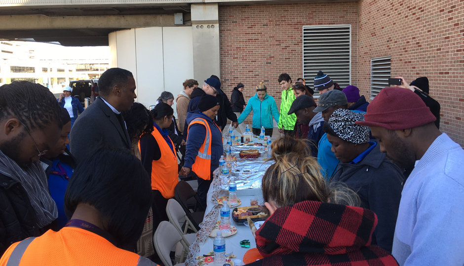 Workers at the Philadelphia International Airport pray for workers' rights before a Thanksgiving feast. They held a 24-hour fast to protest what they say are low wages and unfair treatment from management.