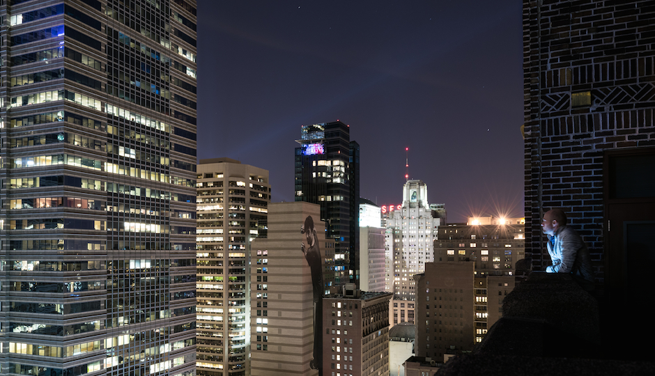 Rooftopping photographer Christopher Olstein (right) enjoys the view.