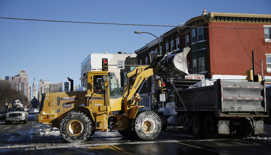 Crews remove snow along Broad Street after a winter storm, Sunday, Jan. 24, 2016, in Philadelphia. (AP Photo/Matt Slocum)
