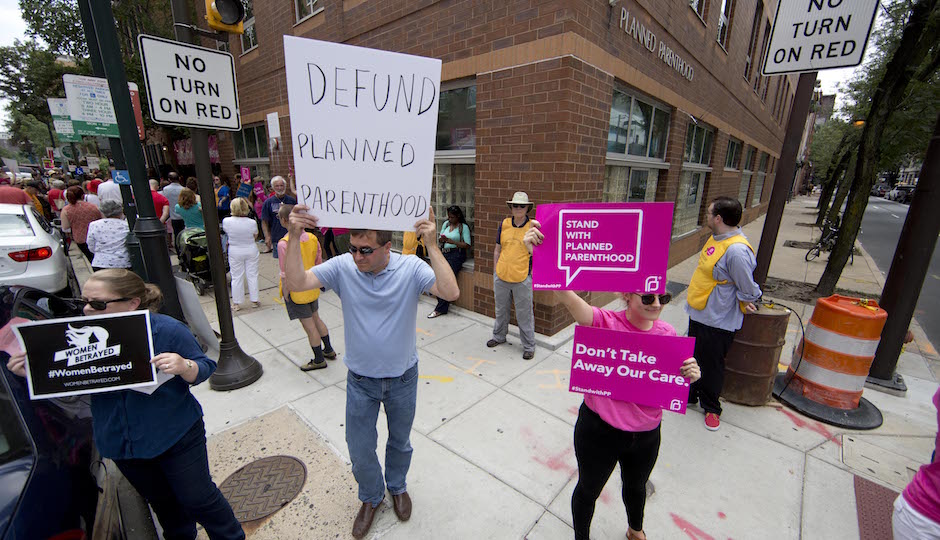 Opponents and supporters of Planned Parenthood demonstrate Tuesday, July 28, 2015, in Philadelphia. Anti-abortion activists are calling for an end to government funding for the nonprofit reproductive services organization. (AP Photo/Matt Rourke)