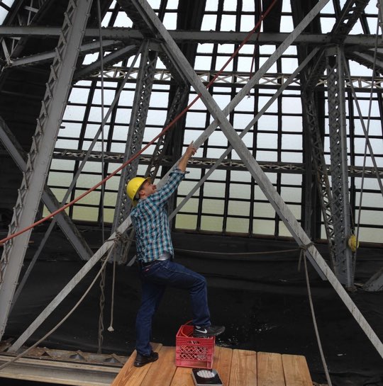 A worker repairs the dome at Memorial Hall, home of the Please Touch Museum