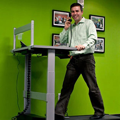 Vynamic CEO Dan Calista on a walking treadmill desk.
