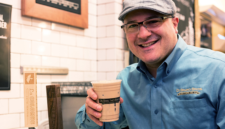 Di Bruno Bros. Emilio Mignucci with a cup of La Colombe Draft Latte.