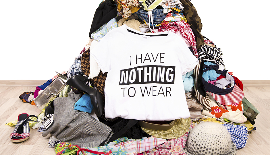 Close up on a untidy cluttered wardrobe with colorful clothes and accessories, many clothes and nothing to wear.