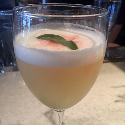 The Royal We - Barrel aged ginever, genever, lemon, sugar, simple syrup, cucumber, sage, orange aromatic bitters, sparkling wine, egg white