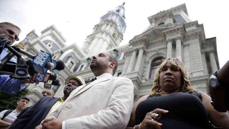 Attorney Brian Mildenberg (center), Tanya Brown-Dickerson (right), mother of Brandon Tate-Brown (Matt Rourke/AP)