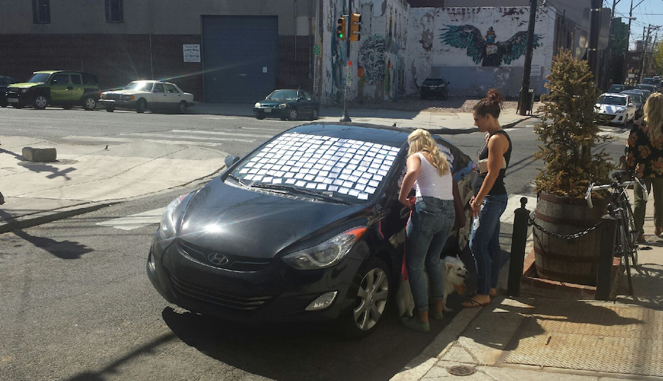 Taking a break from walking the dogs so they can add their own note. (Photo via Eric Wagner)