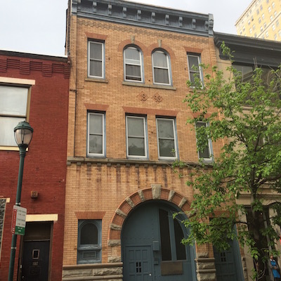 There's a separate entrance for the upper floors, so the first floor is completely severable from the rest of the building, which Zahn currently uses as both working and living space.