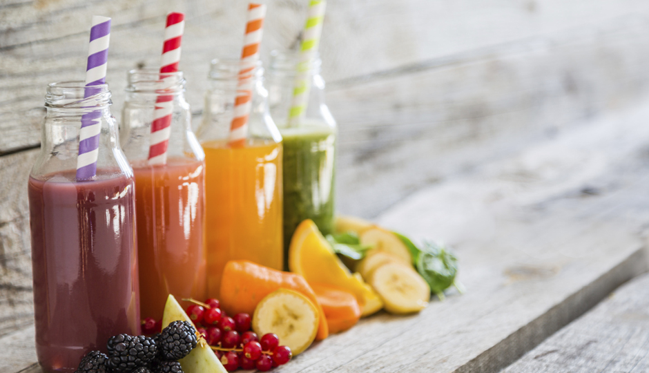Selection of colorful smoothies, rustic wood background, copy space