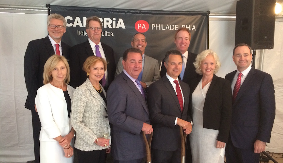 You can't stick a shovel into a steel plate, but there were shovels all the same at today's ceremonial groundbreaking. The participants: Top row, left to right: Greater Philadelphia Chamber of Commerce CEO Rick Wunderling, DAS Architects Principal David Schultz, Pearl Properties Principal Jim Pearlstein, Choice Hotels Chief Development Officer David Pepper. Bottom row, left to right: DAS Architects Principal Sue Davidson, Visit Philadelphia CEO Meryl Levitz, Choice Hotels CEO Steve Joyce, Pearl Properties Principal Reed Slogoff, Choice Hotels Senior Vice President for Upscale Brands Janice Camron, Choice Hotels Director of Development Guy Gridley. |Photo: Sandy Smith