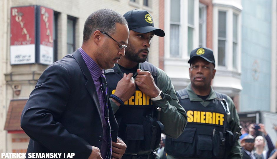 Officer Caesar Goodson, left, one of six Baltimore city police officers charged in connection to the death of Freddie Gray, arrives at a courthouse before receiving a verdict in his trial in Baltimore, Thursday, June 23, 2016.