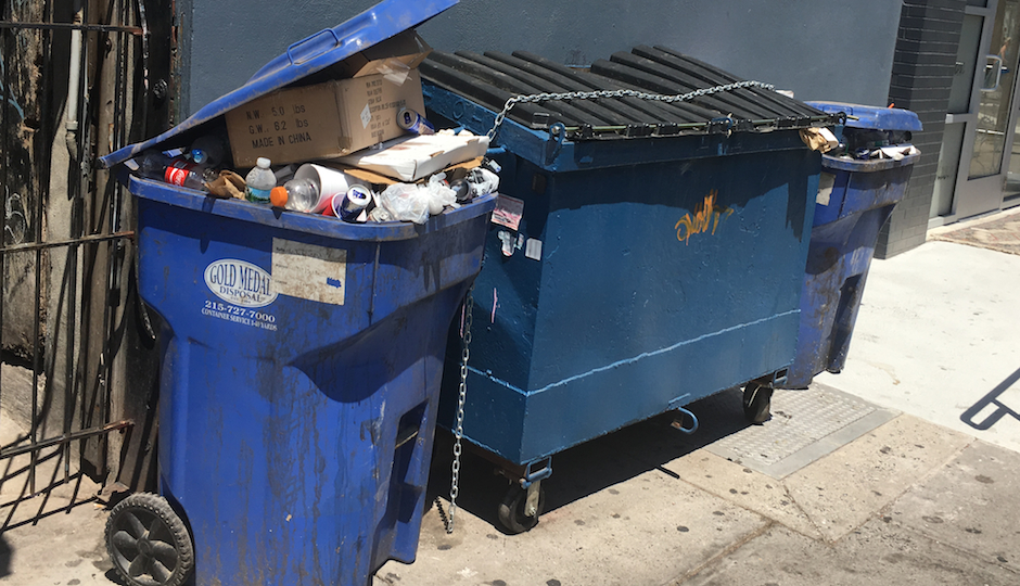 MilkBoy's controversial dumpster sits between two smaller trash containers on South Street. (Photo by Elizabeth Worthington)