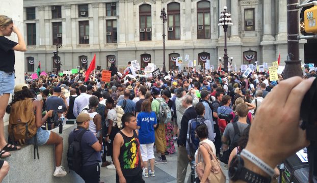 Protestors listen to speakers affiliated with the Philly Coalition for REAL Justice outside of City Hall before marching south of Broad Street.