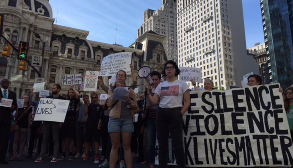 Black Lives Matter protestors gather in front of City Hall during an early morning demonstration.