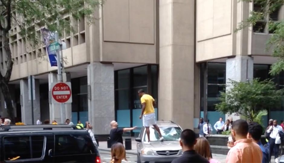 cyclist-stands-on-hood-of-SUV-940x540
