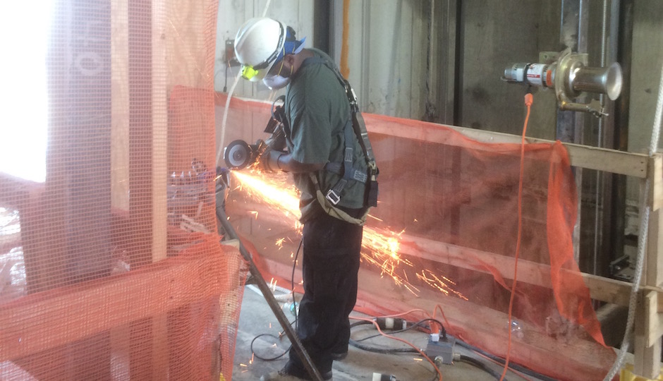 A construction worker cuts a section of pipe on the amenity floor at the soon-to-open AKA University City. Photos: Sandy Smith unless otherwise noted; renderings: Piero Lissoni