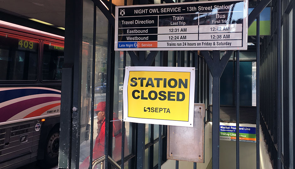 'Station Closed' sign at SEPTA El stop, man smoking in background