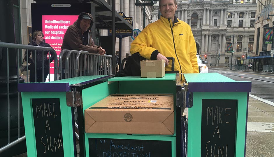Stephen Horcha and his sign cart. Photo by Victor Fiorillo
