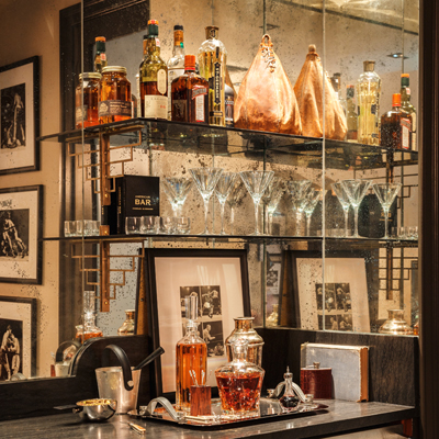 Open shelves in a home's bar area designed by Ashli Mizell | Photograph by Jason Varney