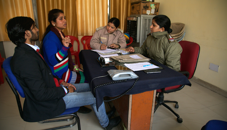 A woman and her husband talk to the marriage cops.