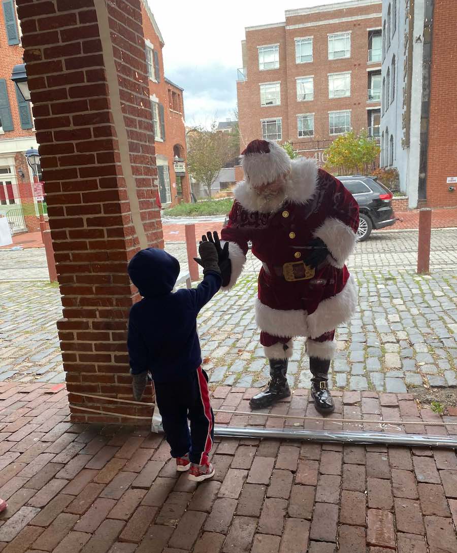 a photo of Philadelphia Santa for hire Santa Kringle behind plastic on South Street