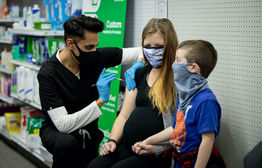 Mayank Amin, a.k.a Dr. Mak, of Skippack Pharmacy, administering the COVID vaccine