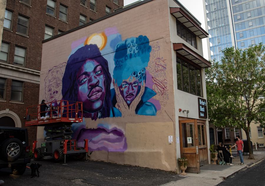 ash ryan working on the lil nas x mural in philadelphia