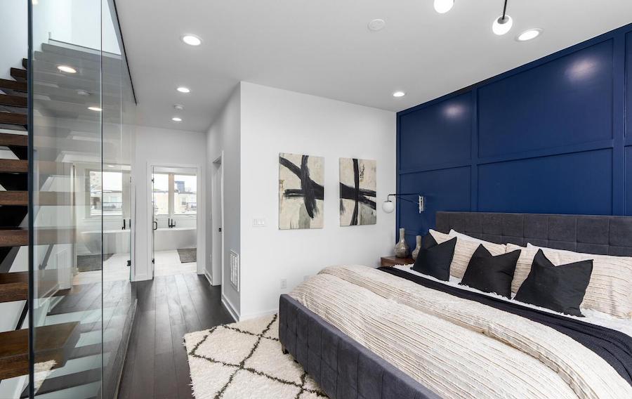 primary bedroom showing floating staircase