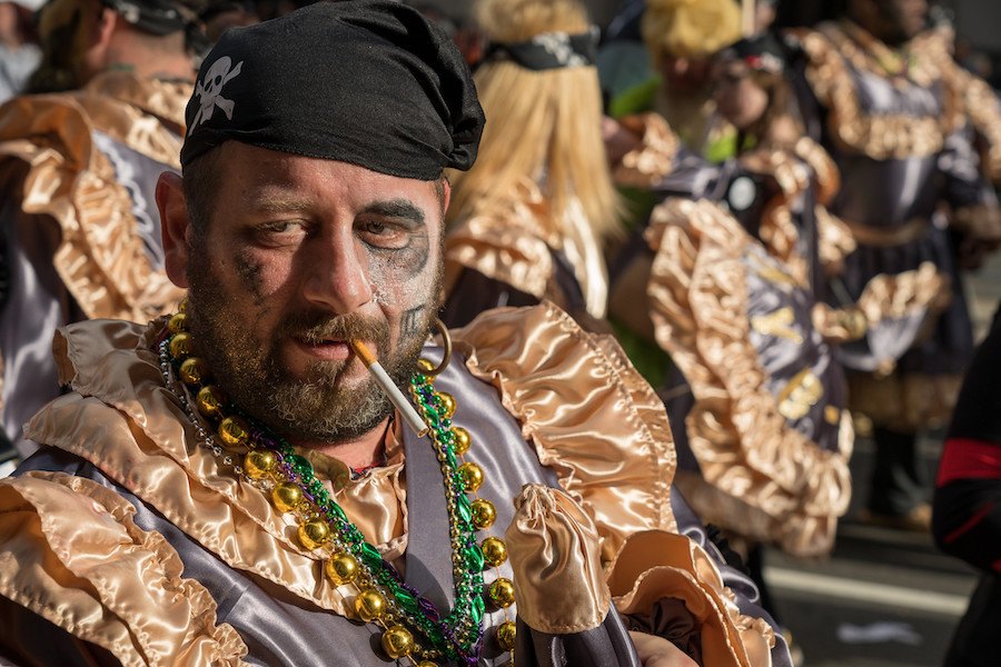 a man smokes a cigarette at the 2019 mummers parade