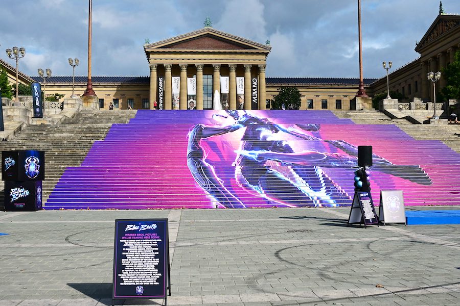 A mural on the Philadelphia Art Museum steps advertising the upcoming Warner Bros. movie Blue Beetle